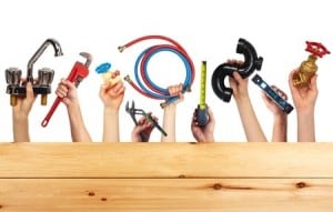 People showing their hands holding plumbing tools