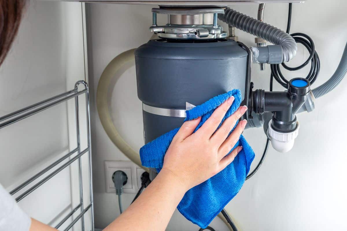 How to find the red button and reset the garbage disposal